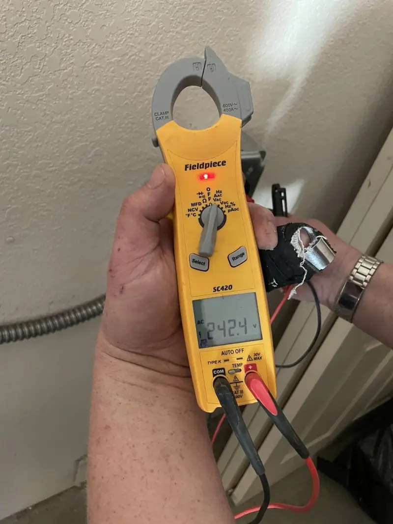 Voltage testing with clamp meter during Outlet Installation in Little Falls